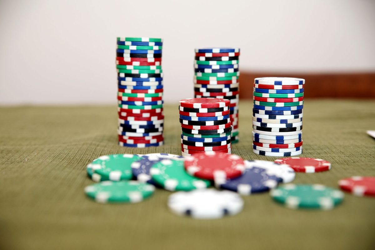 Colourful symbolic chips stacked on a table before a Casino Moments themed evening