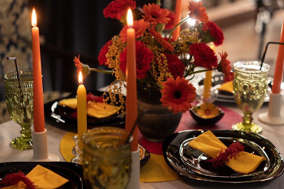 Private dinner party table setting with candles for an intimate themed evening