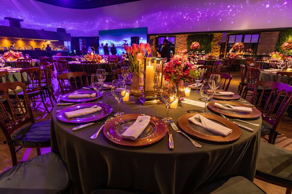 Event hall styled with candlelit tables for a corporate team evening